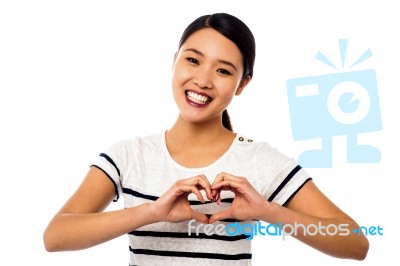 Pretty Woman Making Heart Symbol With Hands Stock Photo