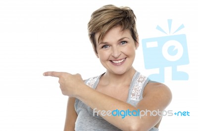 Pretty Woman Pointing Towards Copy Space Area Stock Photo