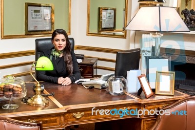 Pretty Woman Posing At Reception Desk Stock Photo