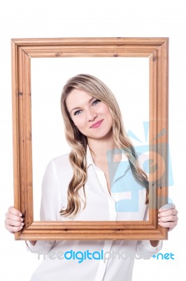 Pretty  Woman Posing Behind  Wooden Frame Stock Photo