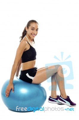 Pretty Woman Relaxing On Big Blue Exercise Ball Stock Photo