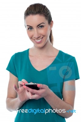 Pretty Woman Using Touch Screen Cellphone Stock Photo