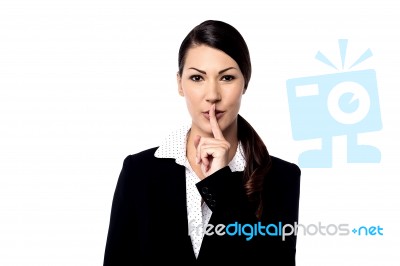 Pretty Woman With Finger On Lips Stock Photo