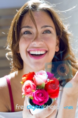 Pretty Woman With Flowers At Home Stock Photo