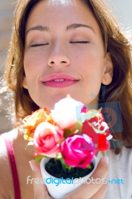 Pretty Woman With Flowers At Home Stock Photo