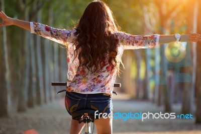 Pretty Young Girl Riding Bike In A Forest Stock Photo