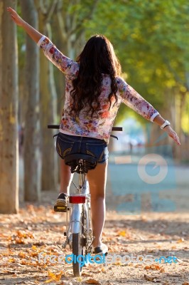 Pretty Young Girl Riding Bike In A Forest Stock Photo