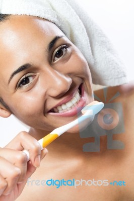 Pretty Young Woman Brushing Her Teeth Stock Photo