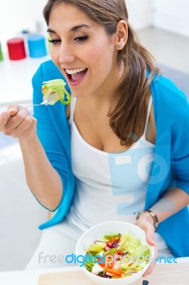 Pretty Young Woman Eating Salad At Home Stock Photo