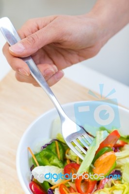 Pretty Young Woman Eating Salad At Home Stock Photo