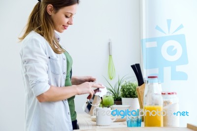 Pretty Young Woman Enjoying Breakfast In The Kitchen Stock Photo