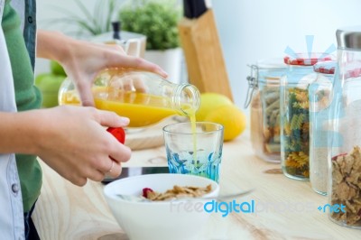 Pretty Young Woman Enjoying Breakfast In The Kitchen Stock Photo