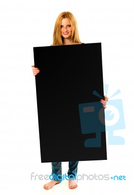 Pretty Young Woman Holding A Black Banner Stock Photo