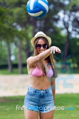 Pretty Young Woman Playing With A Ball In The City Park - Sunset… Stock Photo