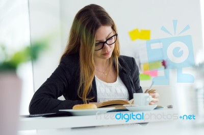 Pretty Young Woman Reading A Book And Having Breakfast At Home Stock Photo