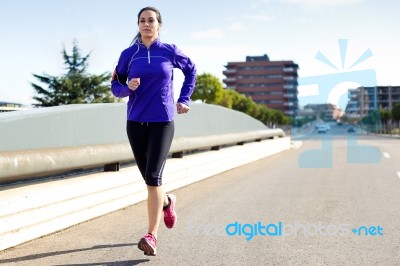 Pretty Young Woman Running In City Stock Photo