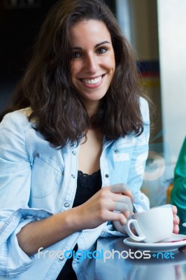 Pretty Young Woman Sitting In A Cafe With A Cup Of Coffee Stock Photo