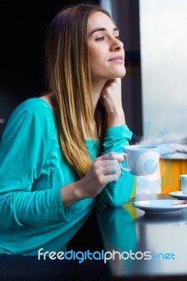 Pretty Young Woman Sitting In A Cafe With A Cup Of Coffee Stock Photo