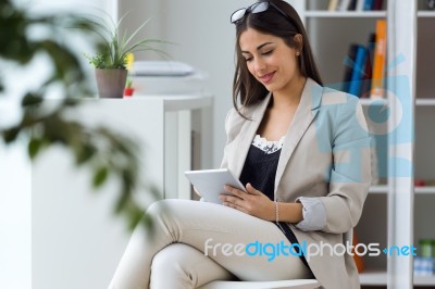 Pretty Young Woman Using Digital Tablet In The Office Stock Photo