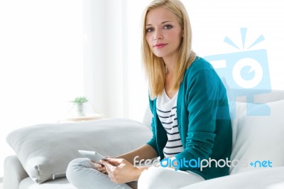 Pretty Young Woman Using Her Digital Tablet At Home Stock Photo