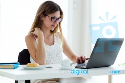 Pretty Young Woman Using Her Laptop At Home Stock Photo