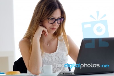 Pretty Young Woman Using Her Laptop At Home Stock Photo