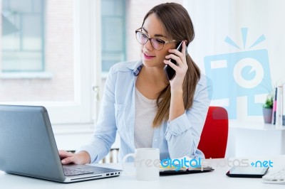 Pretty Young Woman Using Her Laptop In The Office Stock Photo