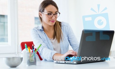 Pretty Young Woman Using Her Laptop In The Office Stock Photo