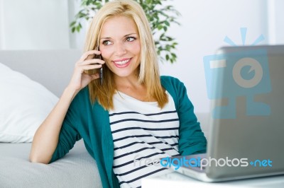 Pretty Young Woman Working And Using Her Mobile Phone Stock Photo