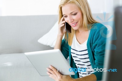 Pretty Young Woman Working And Using Her Mobile Phone Stock Photo