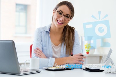 Pretty Young Woman Working In Her Office Stock Photo