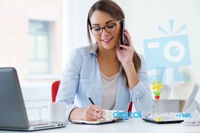 Pretty Young Woman Working In Her Office Stock Photo