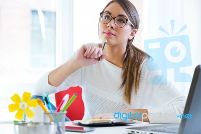 Pretty Young Woman Working In Her Office Stock Photo