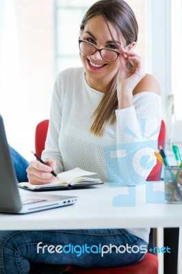 Pretty Young Woman Working In Her Office Stock Photo