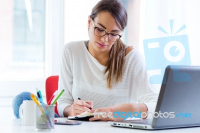 Pretty Young Woman Working In Her Office Stock Photo