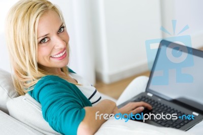 Pretty Young Woman Working With Laptop At Home Stock Photo