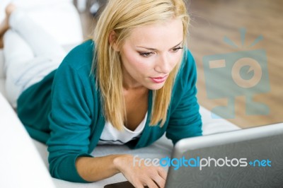 Pretty Young Woman Working With Laptop At Home Stock Photo