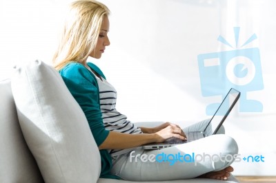 Pretty Young Woman Working With Laptop At Home Stock Photo