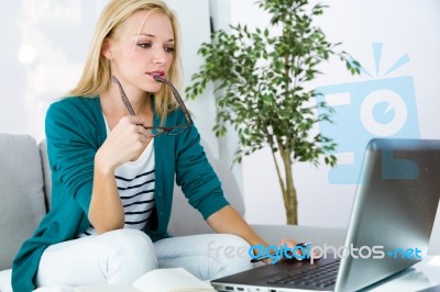 Pretty Young Woman Working With Laptop At Home Stock Photo