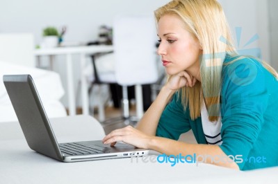 Pretty Young Woman Working With Laptop At Home Stock Photo