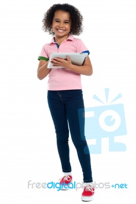 Primary Child With A Tablet Pc Smiling Cheerfully Stock Photo