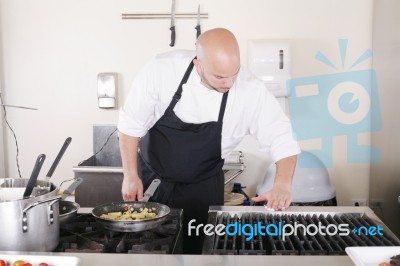 Professional Chef Cleaning The Kitchen Stock Photo