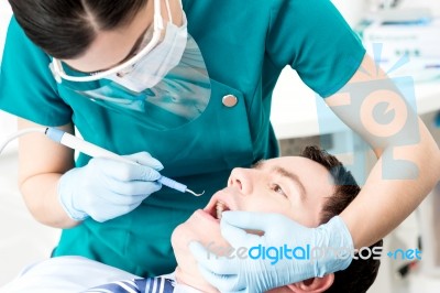 Professional Dentist Doing Teeth Checkup Stock Photo