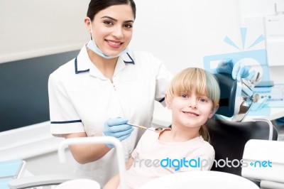 Professional Dentist Posing With Girl Child Stock Photo