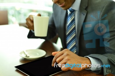 Professional Using A Tablet Computer At Cafe Stock Photo