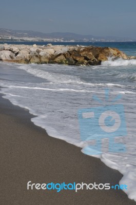 Puerto Banus Beach And Stone Pier Stock Photo