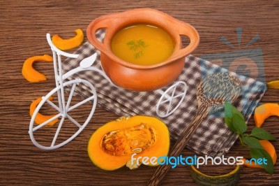 Pumpkin Soup In Clay Pot With Fresh Pumpkins Stock Photo