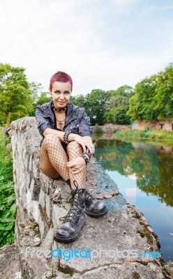 Punk Girl Sitting On The Dike Stock Photo