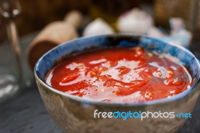 Pureed Tomatoes In A Ceramic Dish On A Table Stock Photo