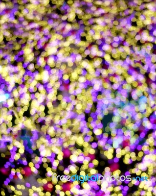 Purple, Pink And Yellow Bokeh On Dark Background Stock Photo